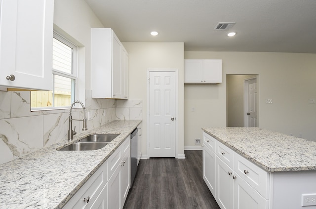 kitchen with dark wood-type flooring, white cabinets, sink, and light stone counters