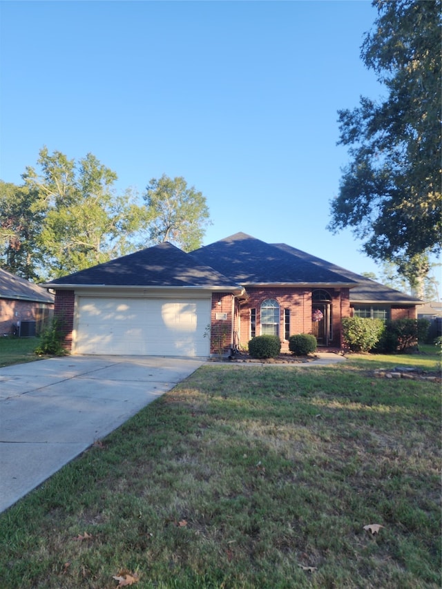 ranch-style house featuring a garage and a front lawn