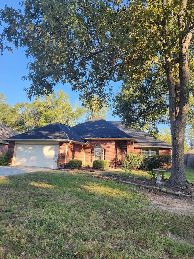 ranch-style home featuring a garage and a front lawn