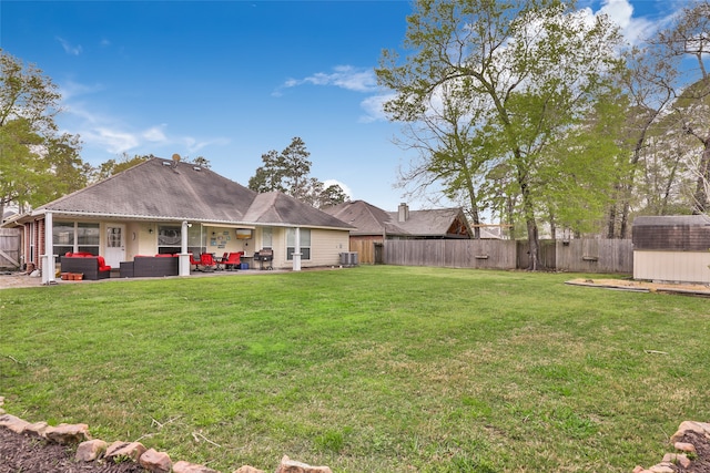 view of yard with a storage shed, a patio area, and central AC unit