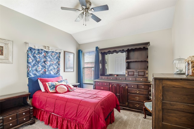 carpeted bedroom featuring ceiling fan and vaulted ceiling