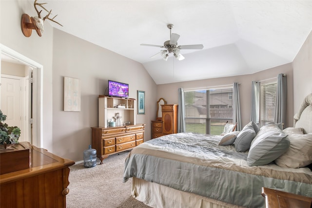 bedroom with lofted ceiling, ceiling fan, and light carpet