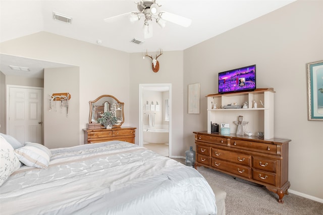 bedroom featuring light carpet, ceiling fan, and ensuite bath