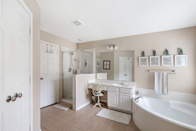 bathroom featuring tile patterned floors, vanity, and shower with separate bathtub