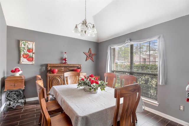 dining space featuring lofted ceiling, dark hardwood / wood-style floors, and a chandelier