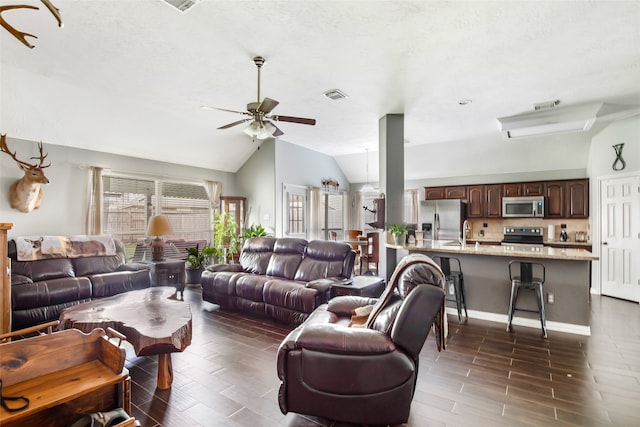 living room featuring ceiling fan, dark hardwood / wood-style floors, sink, vaulted ceiling, and a textured ceiling