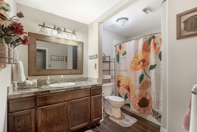 bathroom with vanity, toilet, and a shower with shower curtain