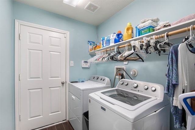 laundry room with independent washer and dryer and dark hardwood / wood-style flooring