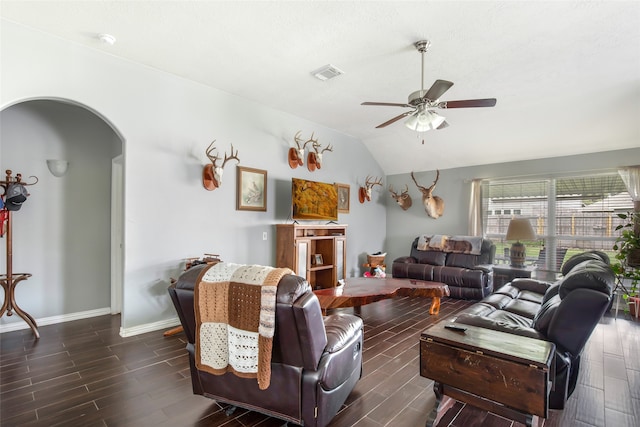 living room featuring ceiling fan, lofted ceiling, and dark wood-type flooring