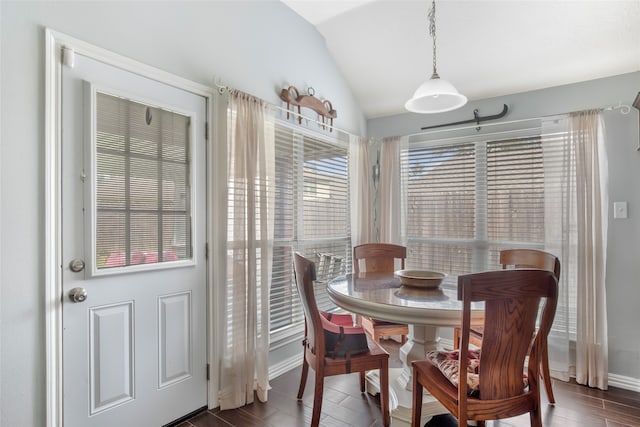 dining room featuring vaulted ceiling and dark hardwood / wood-style flooring