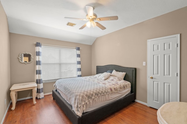 bedroom with vaulted ceiling, wood-type flooring, and ceiling fan