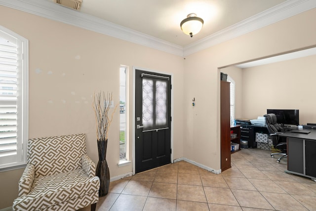 foyer entrance with crown molding and light tile patterned floors