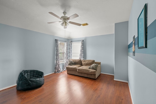 sitting room featuring hardwood / wood-style floors, a textured ceiling, and ceiling fan