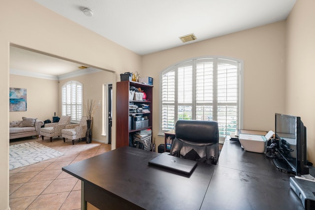 office area with ornamental molding and light tile patterned floors