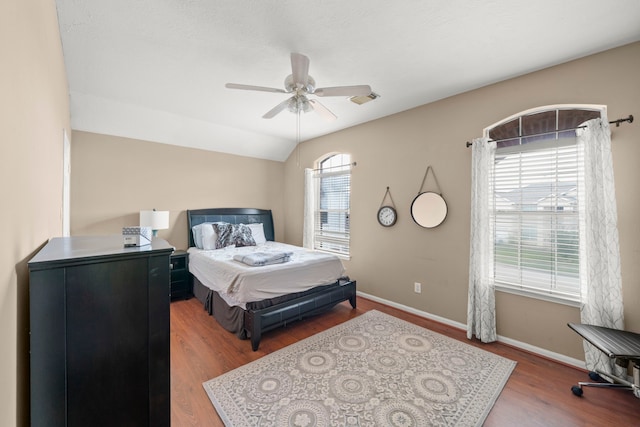 bedroom with vaulted ceiling, hardwood / wood-style flooring, and ceiling fan