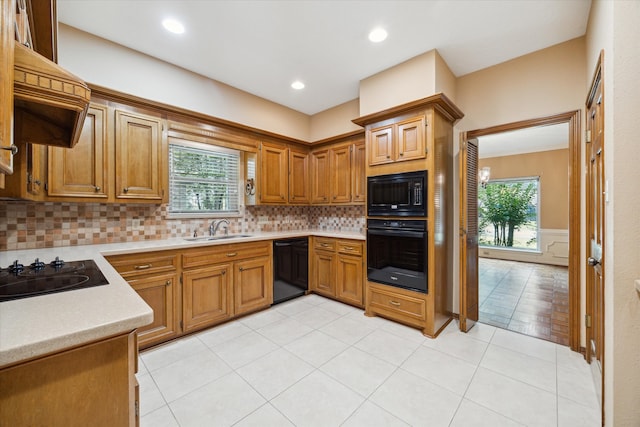 kitchen featuring black appliances, plenty of natural light, tasteful backsplash, and sink