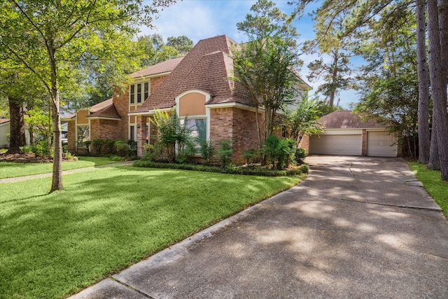 view of front of house featuring a front yard, a garage, and an outdoor structure