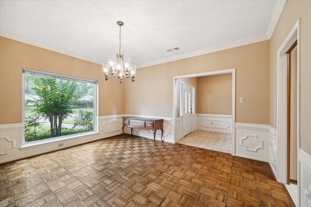 unfurnished dining area featuring an inviting chandelier, crown molding, parquet floors, and a textured ceiling