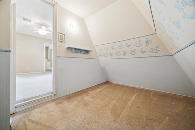 interior space with ceiling fan and vaulted ceiling