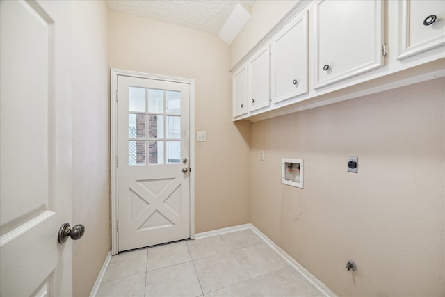 washroom featuring washer hookup, cabinets, a textured ceiling, light tile patterned flooring, and electric dryer hookup