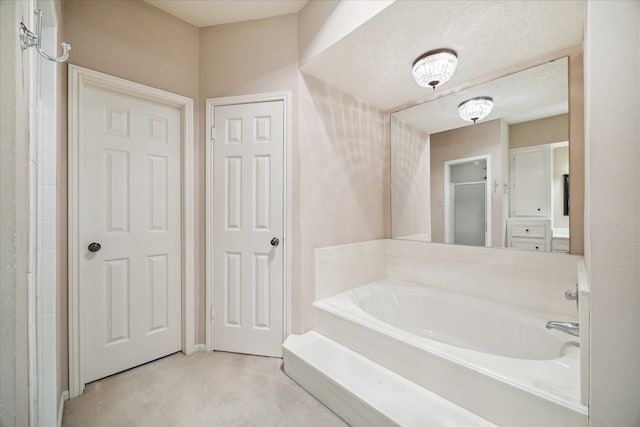 bathroom featuring a textured ceiling and independent shower and bath