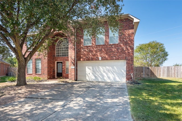 view of front property featuring central AC, a front yard, and a garage