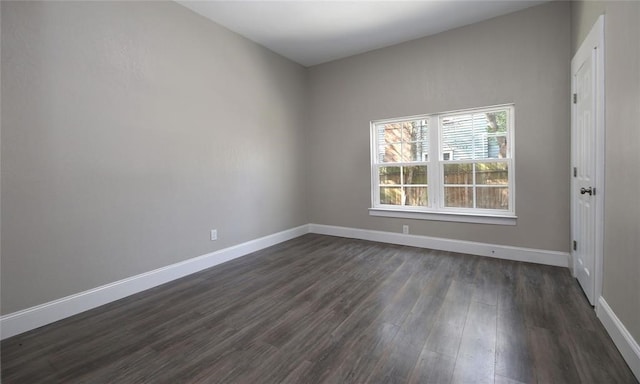 unfurnished room featuring dark wood-type flooring