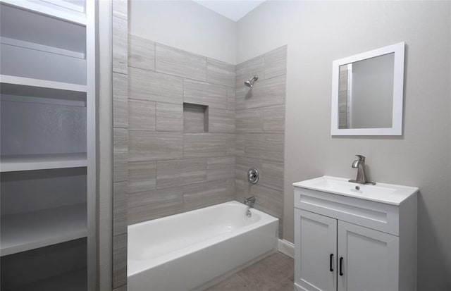 bathroom featuring vanity and tiled shower / bath