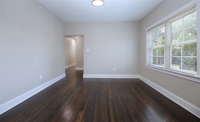 spare room featuring dark wood-type flooring