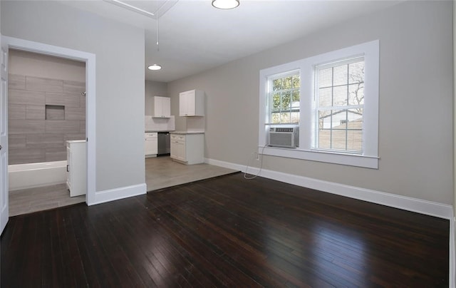 unfurnished living room featuring cooling unit and dark wood-type flooring