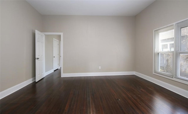 empty room with dark hardwood / wood-style floors