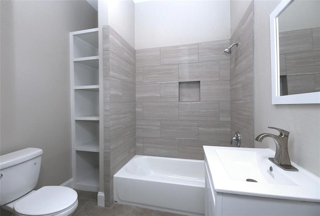 full bathroom featuring vanity, tiled shower / bath, tile patterned floors, built in shelves, and toilet