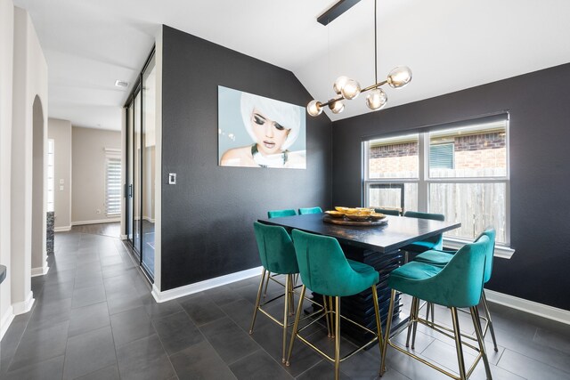 tiled dining room with lofted ceiling and an inviting chandelier