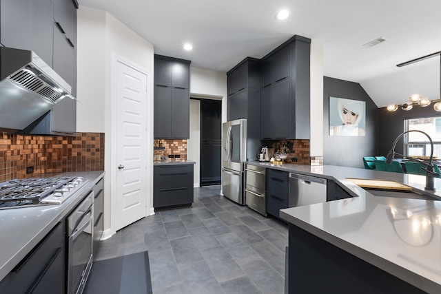 kitchen with tasteful backsplash, sink, vaulted ceiling, decorative light fixtures, and extractor fan