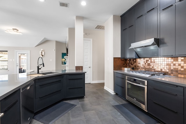 kitchen featuring appliances with stainless steel finishes, sink, and decorative backsplash