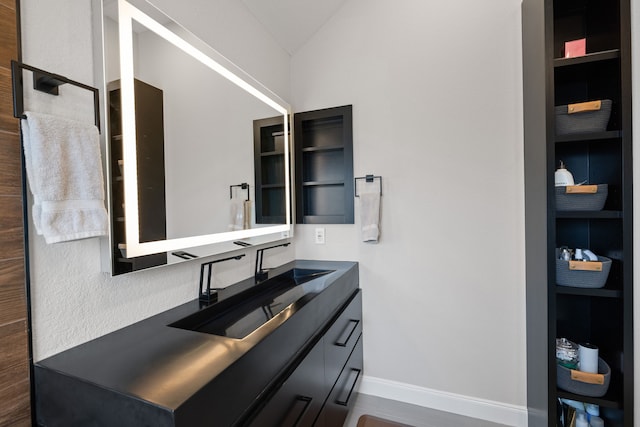 bathroom with vanity and vaulted ceiling