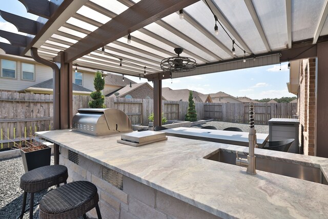 view of patio featuring a pergola, area for grilling, and sink