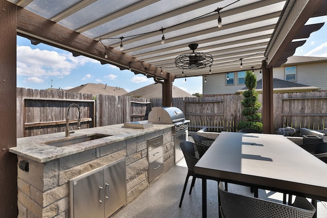 view of patio featuring an outdoor kitchen, sink, area for grilling, and a pergola