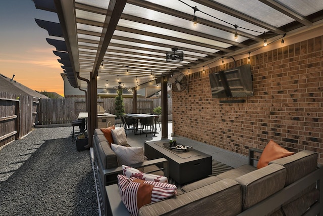 patio terrace at dusk featuring outdoor dining area, a fenced backyard, a pergola, and an outdoor hangout area