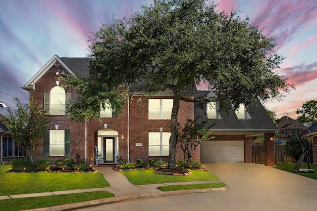 view of front facade featuring a garage and a yard