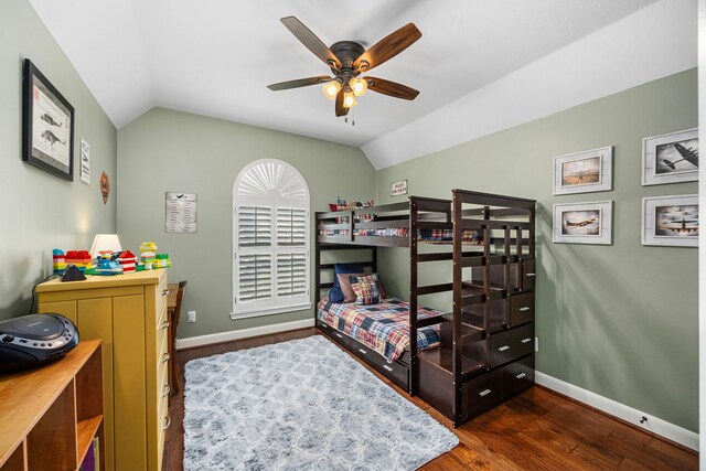 bedroom featuring dark wood-type flooring, lofted ceiling, and ceiling fan