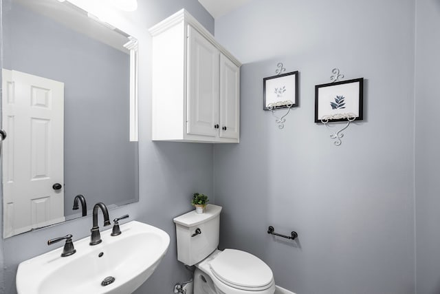 bathroom featuring toilet and sink