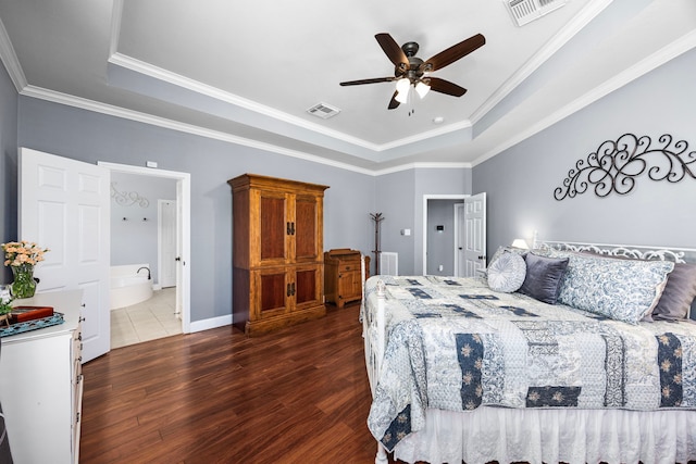 bedroom featuring ceiling fan, a tray ceiling, dark hardwood / wood-style flooring, and ornamental molding