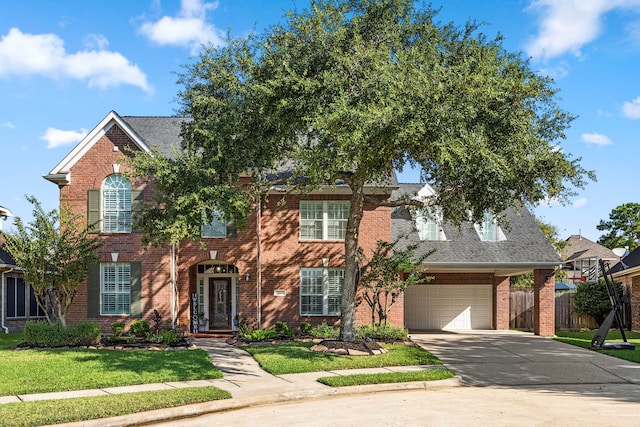 front facade featuring a front lawn and a garage