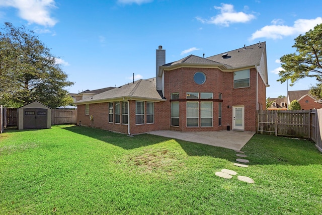 rear view of property featuring a shed, a lawn, and a patio area