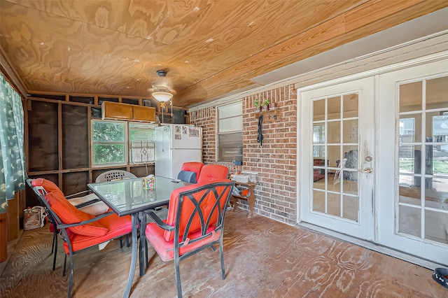 sunroom / solarium featuring french doors