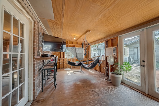 unfurnished sunroom featuring wood ceiling and a wealth of natural light