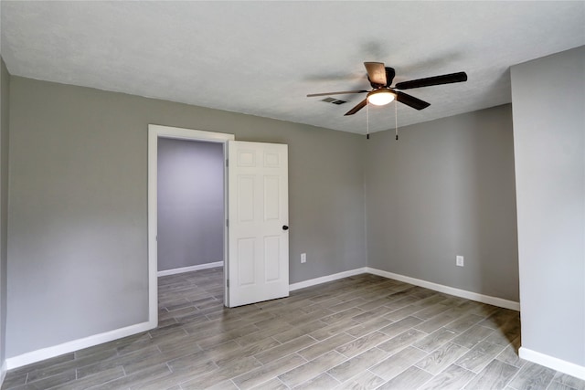 spare room with ceiling fan and light wood-type flooring