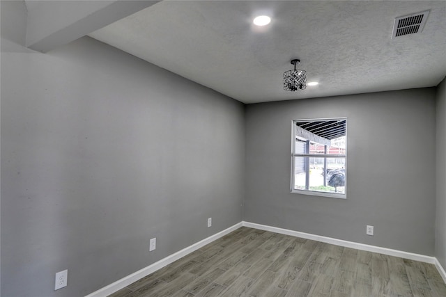 spare room featuring light hardwood / wood-style floors