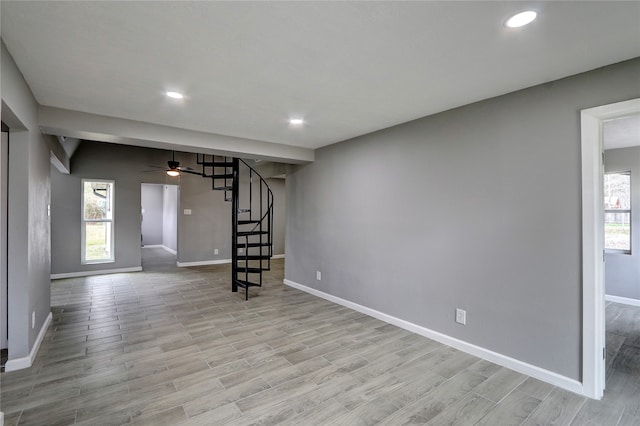 unfurnished living room featuring light hardwood / wood-style floors and ceiling fan